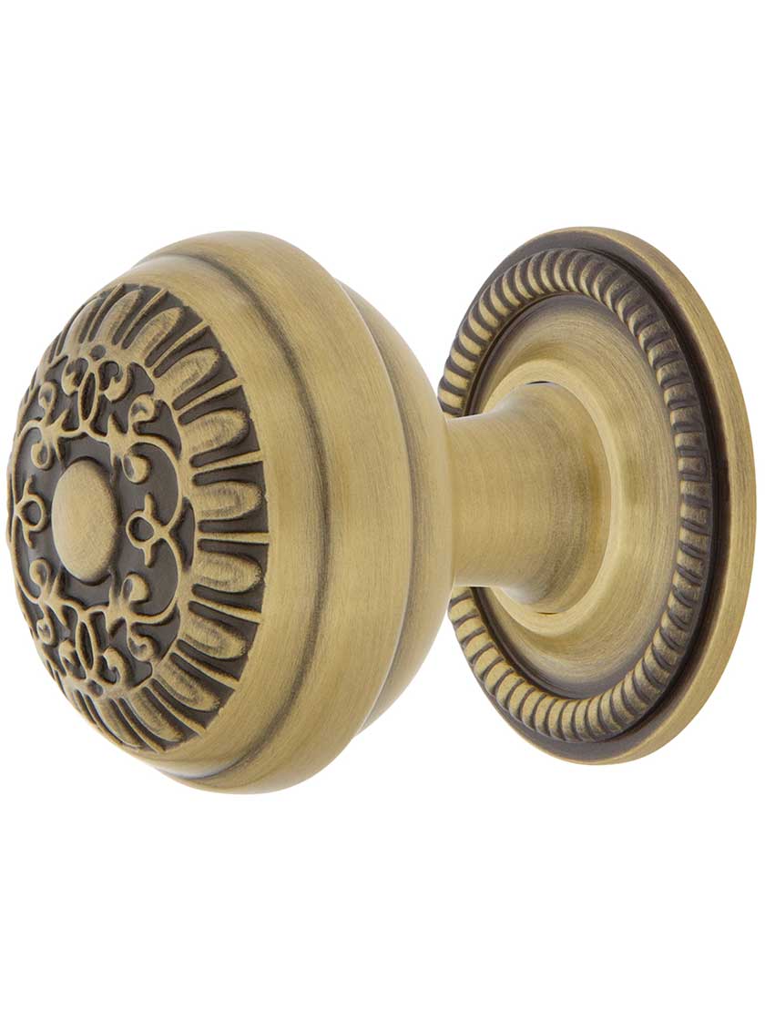 Egg and Dart Cabinet Knob - 1 3/8 inch Diameter with Rope Rosette in Antique Brass.